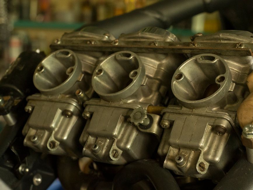 Detailed view of a carburetor, showcasing mechanical precision and engineering.